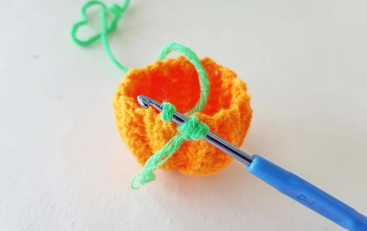 Crochet Pumpkin Step 22 against a white background