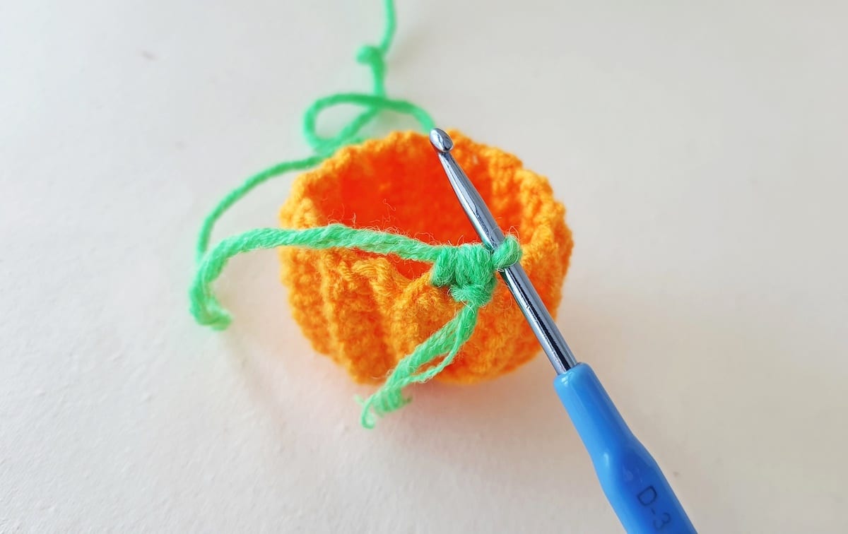 Crochet Pumpkin Step 23 against a white background