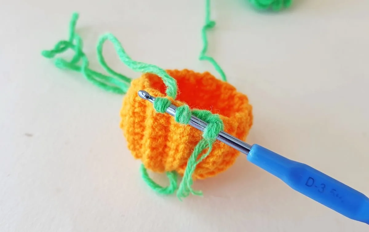 Crochet Pumpkin Step 24 against a white background