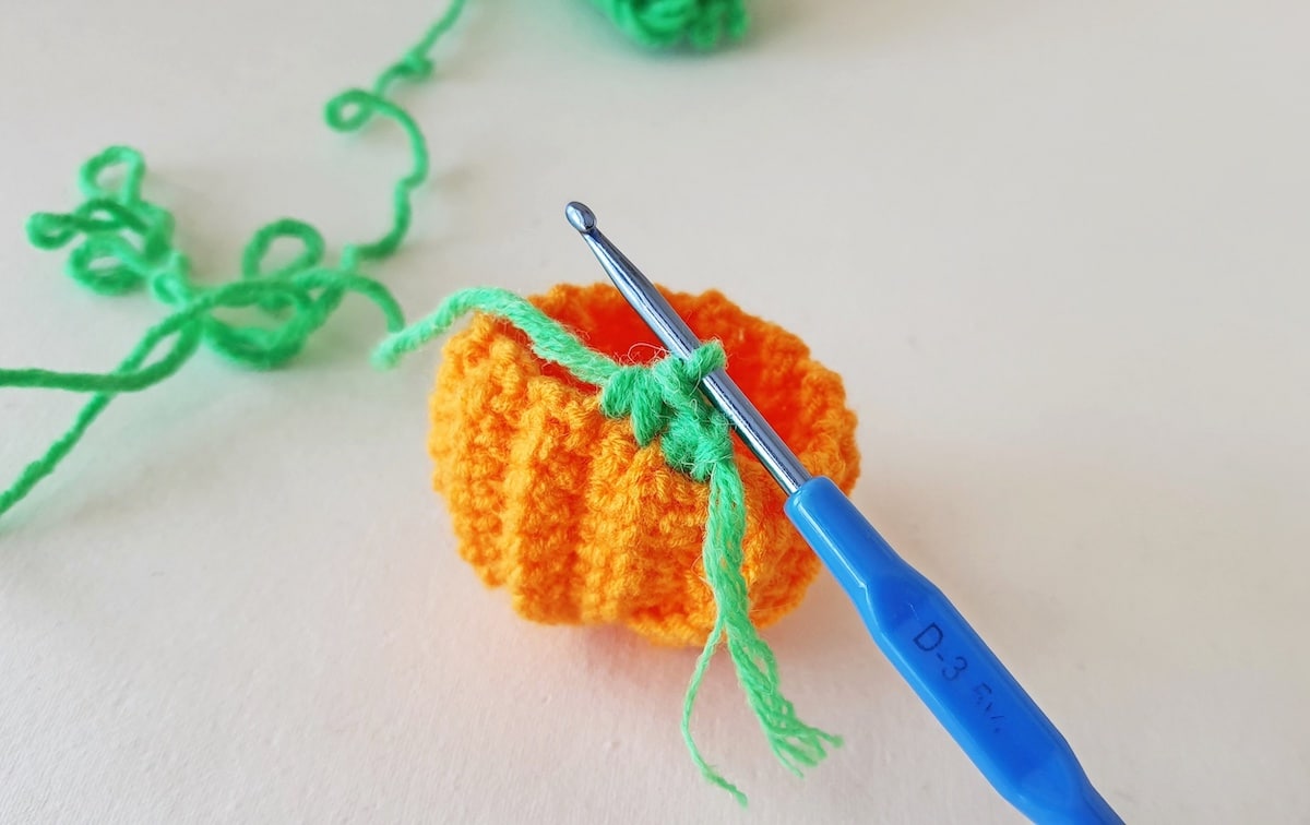 Crochet Pumpkin Step 25 against a white background