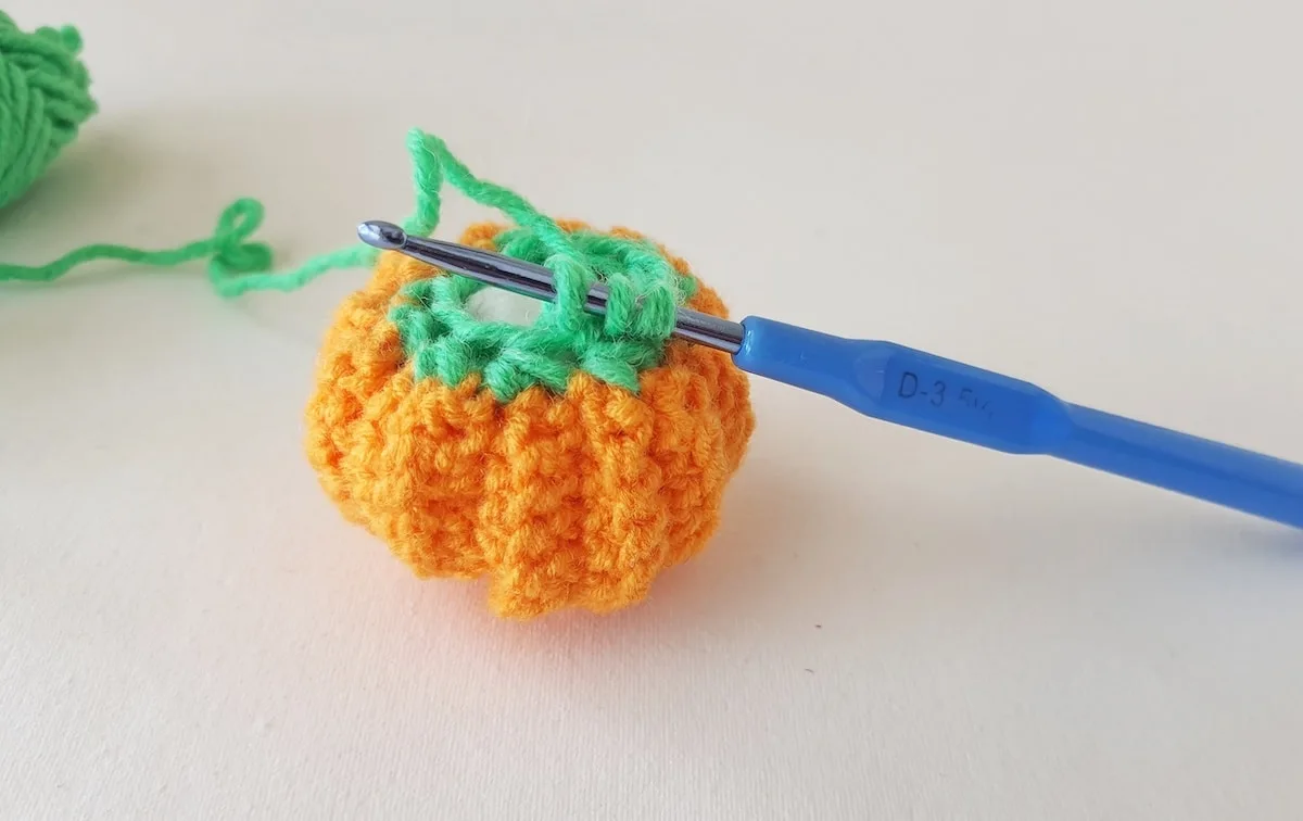 Crochet Pumpkin Step 28 against a white background