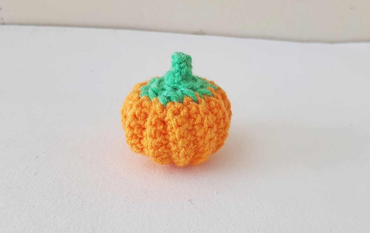 Crochet Pumpkin Step 32 against a white background