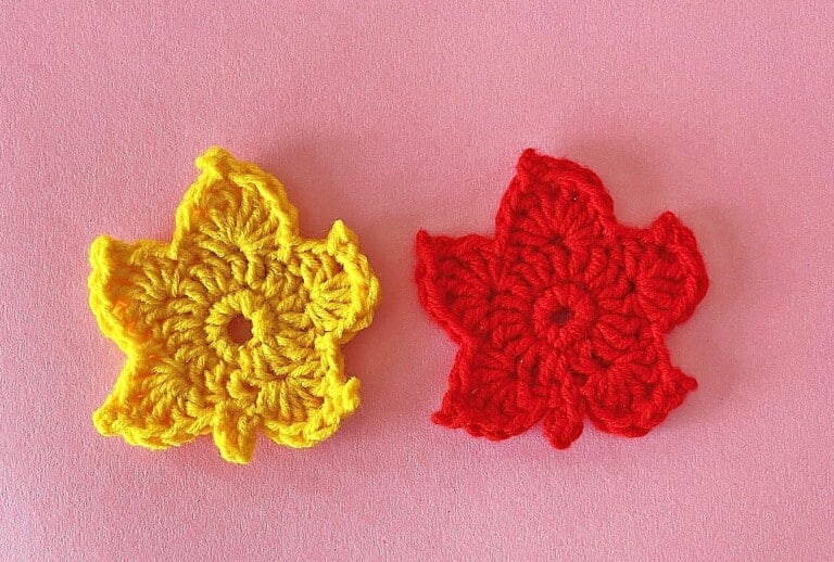 Maple Leaf Crochet Pattern Two crocheted leaves on a pink background.