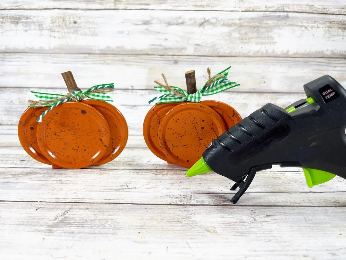 Canning Lid Pumpkins Step 8 with hot glue gun