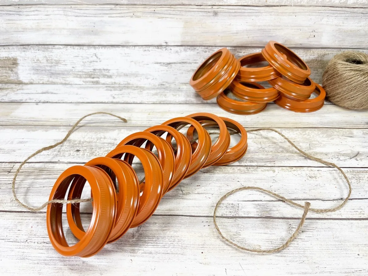 Canning Ring Pumpkin Step 2 with twin and rings on a white wood backdrop