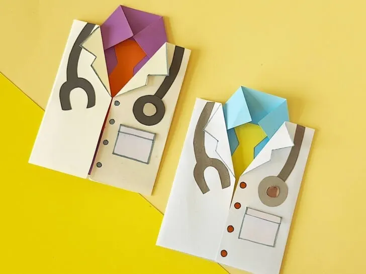 Two origami doctor card outfits on a yellow background.