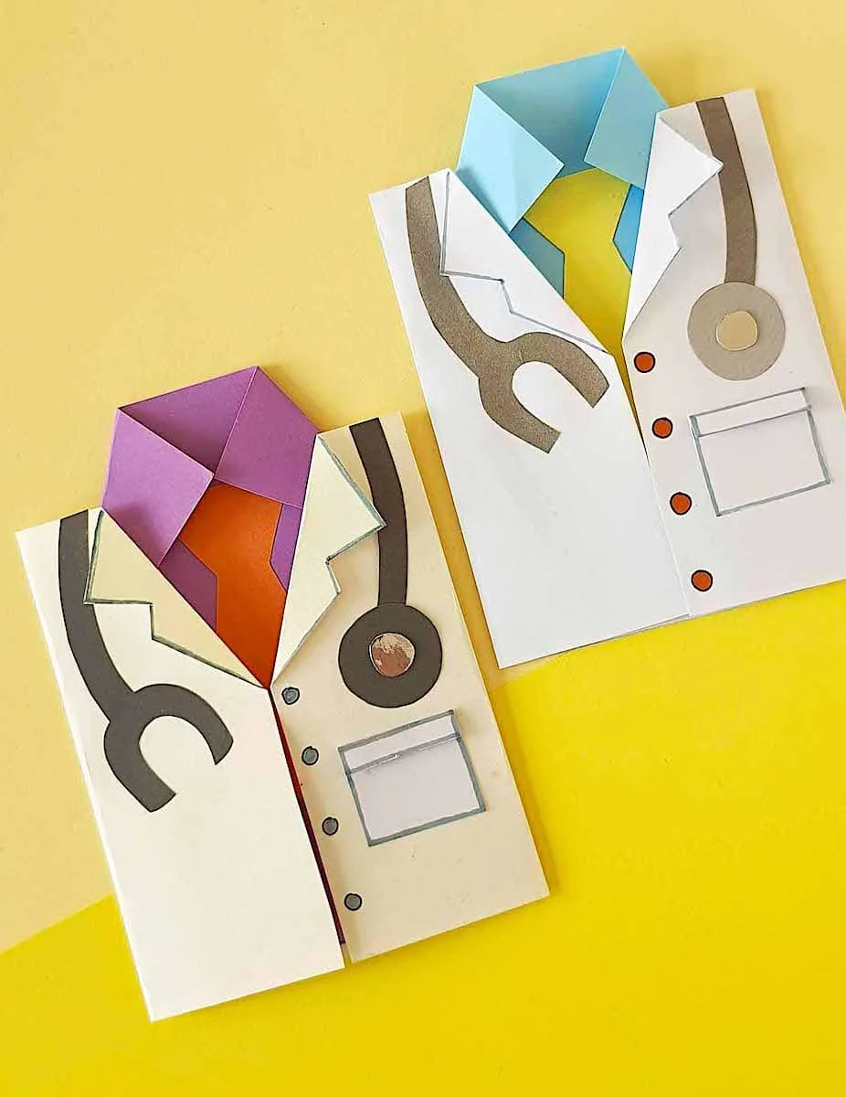 A pair of paper doctor cards on a yellow background.