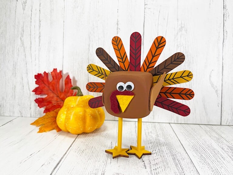 Foam Dice Turkey with a pumpkin and red fall leaves.