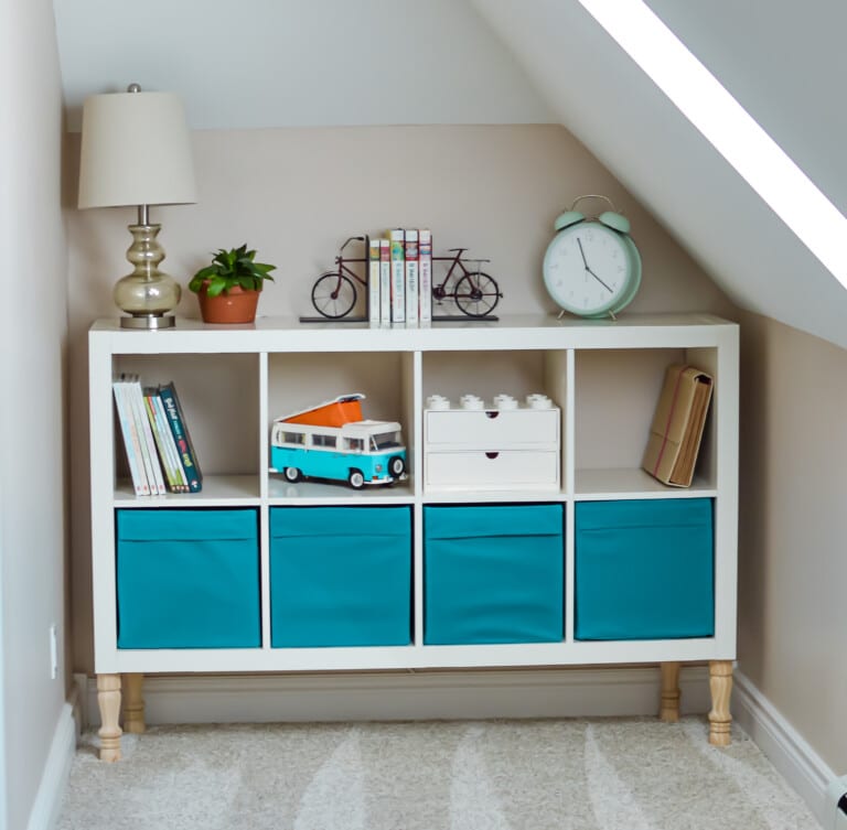 A blue and white bookcase in an attic.