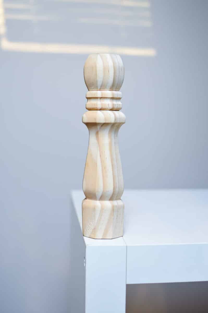 A wooden chess piece on top of a white table.