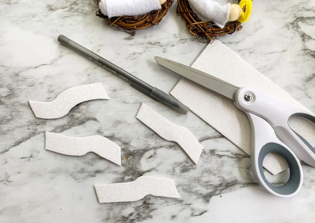 A pair of Emmanuel Wreath scissors on a marble table.