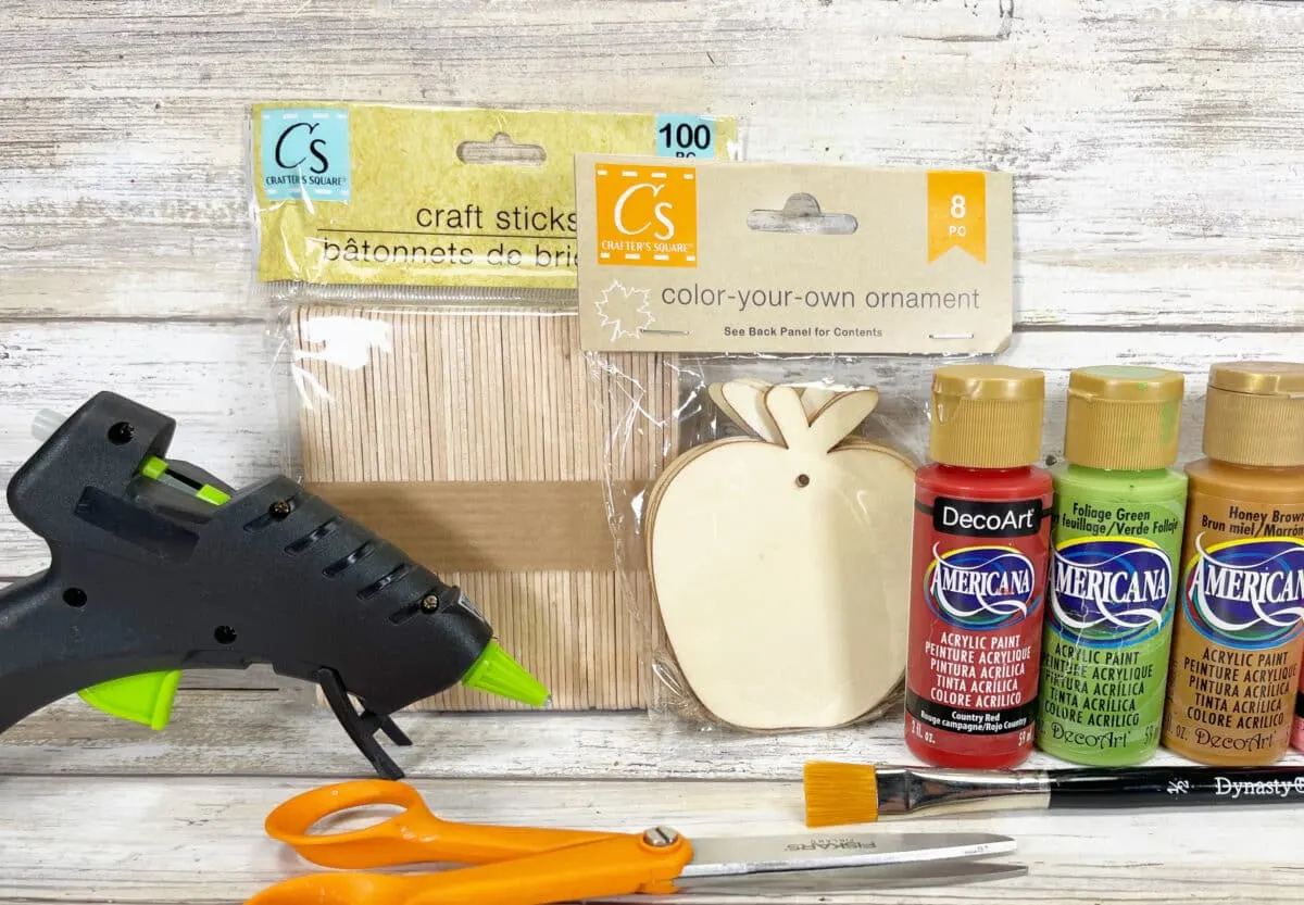 A Candy Apple Craft kit with a glue gun and scissors.