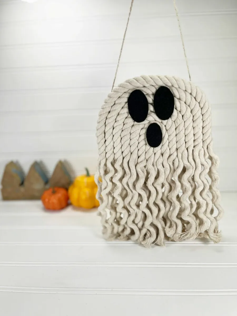 A white rope ghost hanging on a wall.