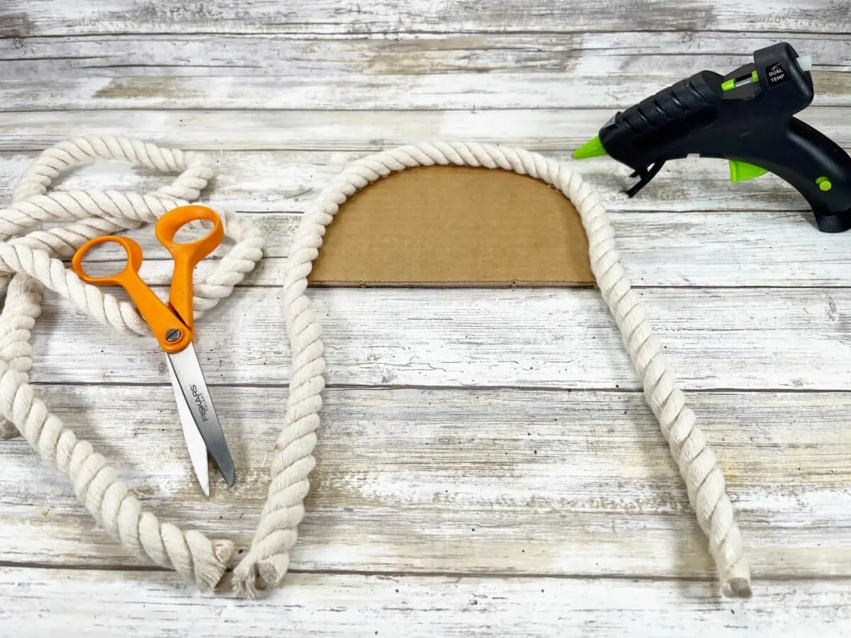 A pair of scissors and a pair of scissors next to a piece of rope.