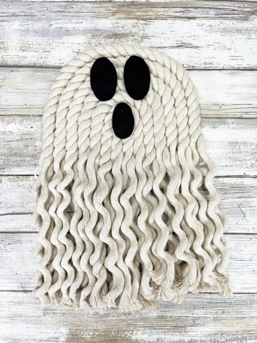 A crocheted ghost hat with black eyes.