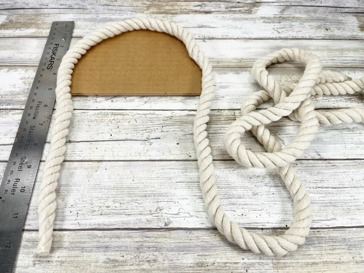 A rope measuring tape and a ruler on a wooden table.
