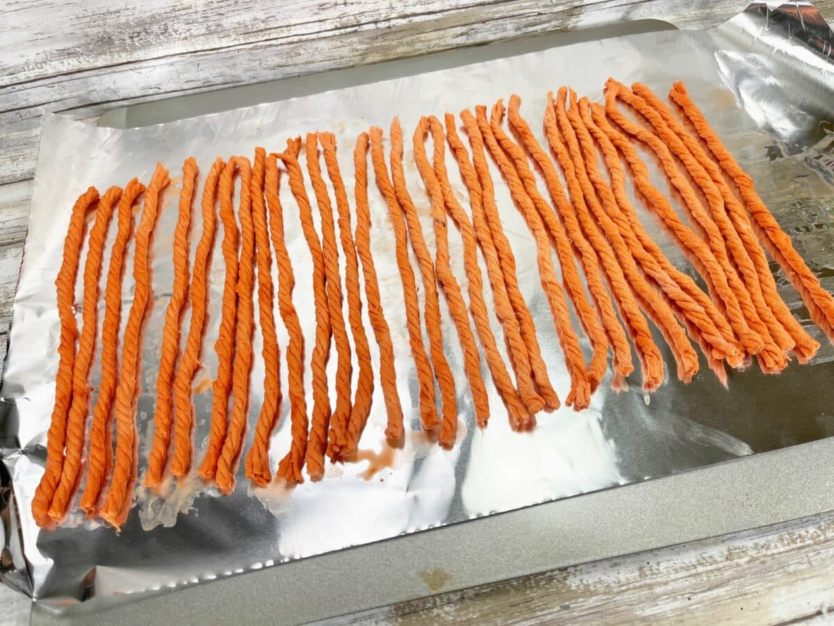 Carrot sticks on a baking sheet.