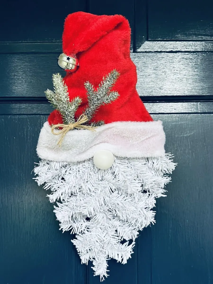 A Santa hat hanging on a door.