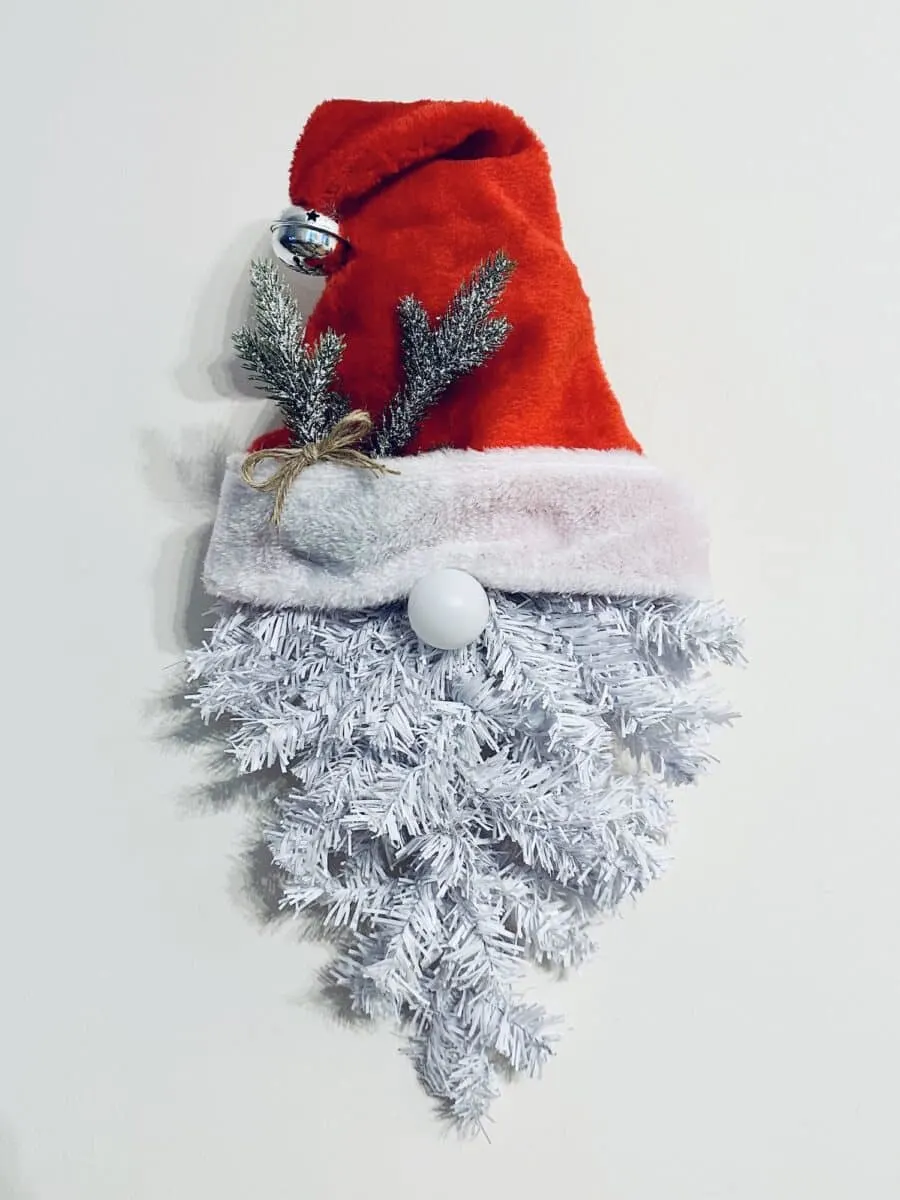 A Santa hat hanging on a wall.