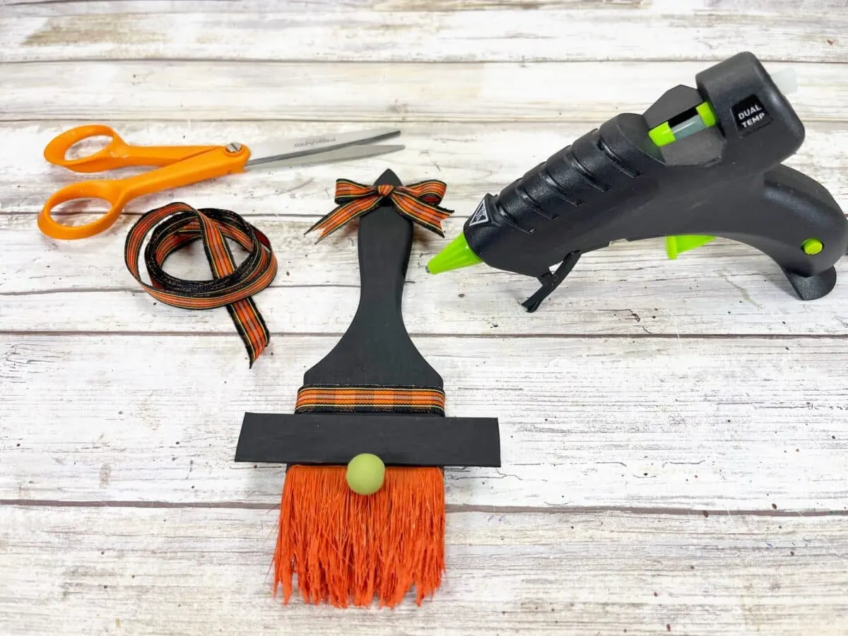 A witch's broom, scissors and glue.