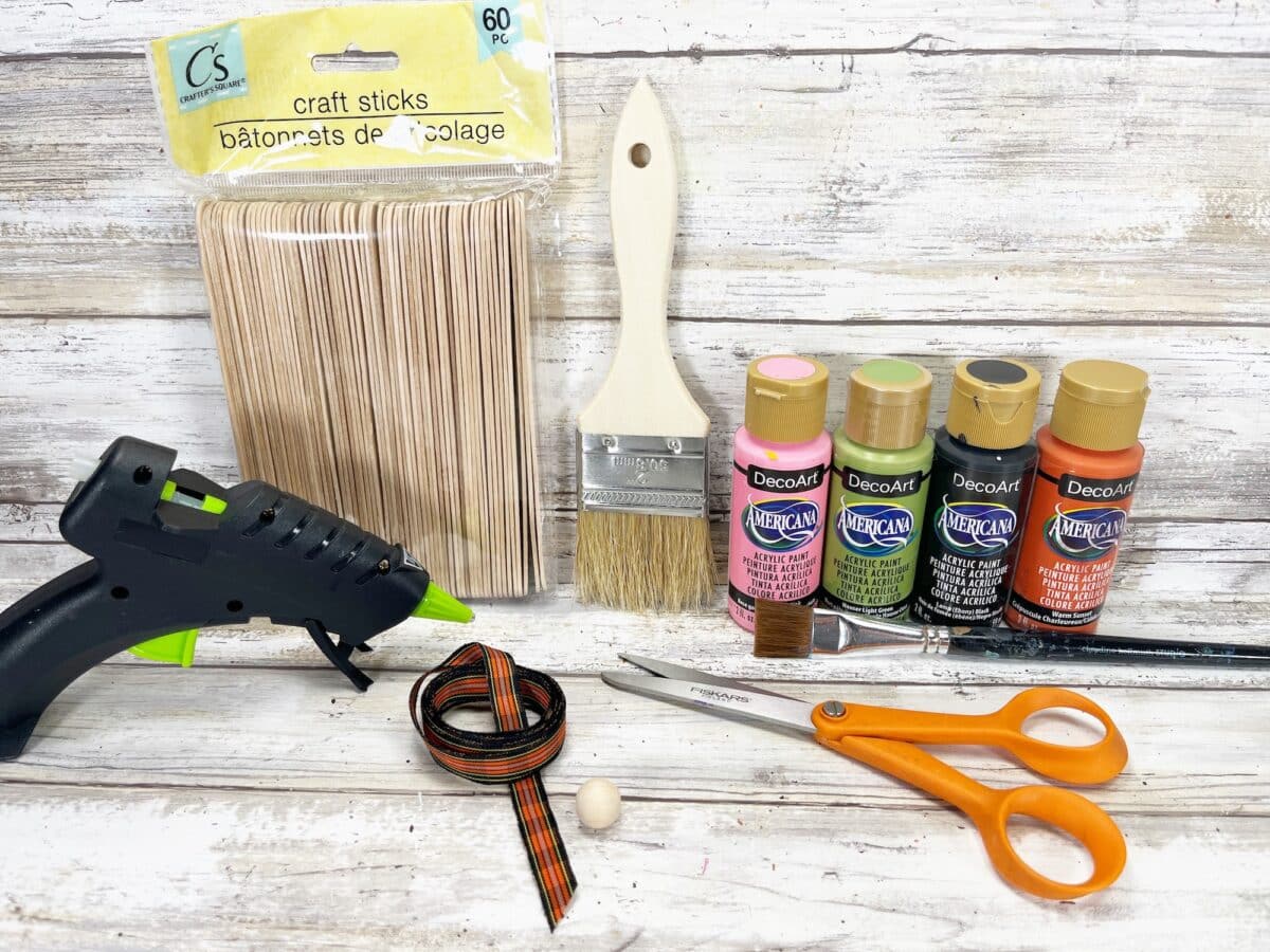 A craft kit with paint, glue, scissors, and paint brushes.