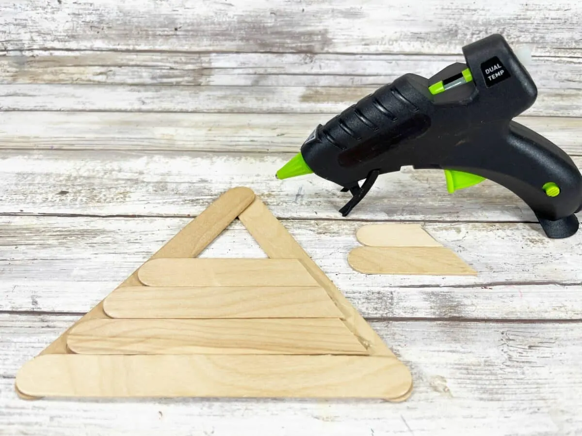 A glue gun with a triangle on top of it.