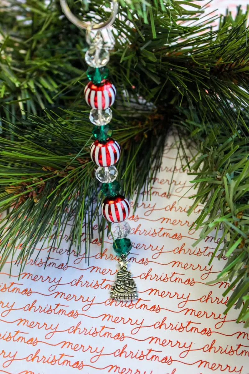 A Christmas ornament on a Christmas tree, resembling a festive Christmas keychain.