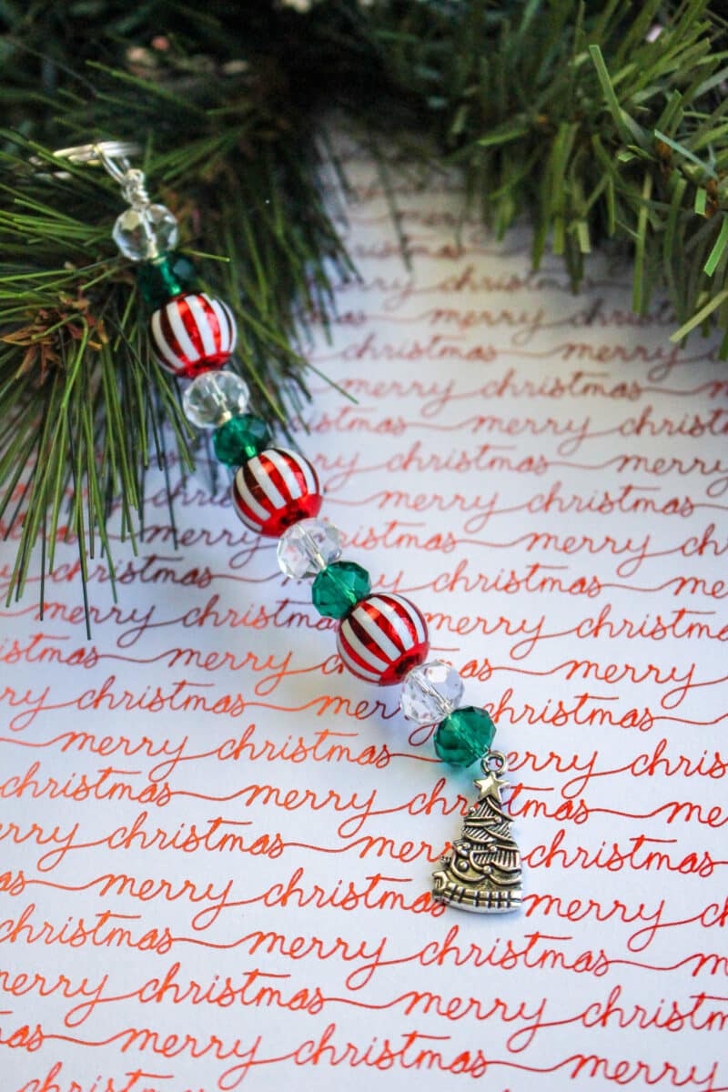 A beaded christmas ornament on a piece of paper.