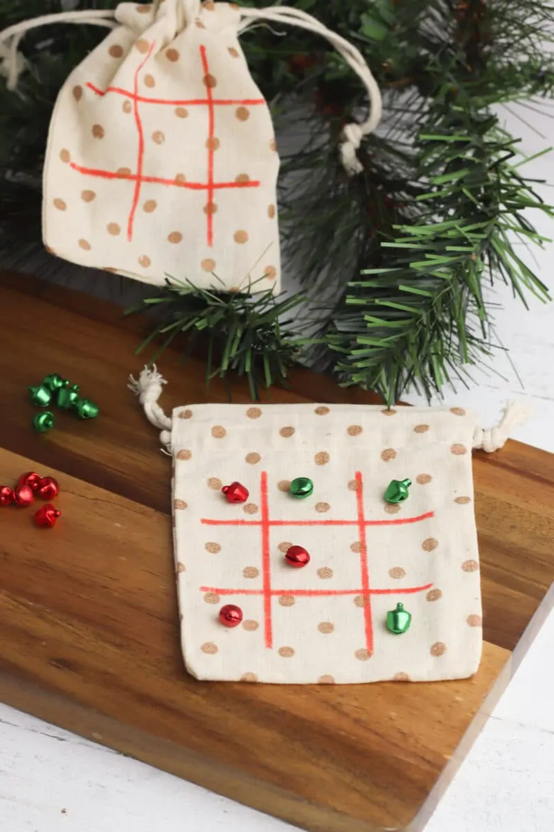Two Christmas tic tac toe bags displayed on a cutting board.