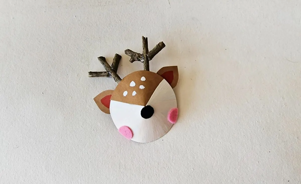 A reindeer head made out of clay on a white surface.