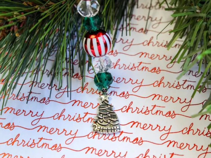 A christmas ornament hangs from a christmas tree.