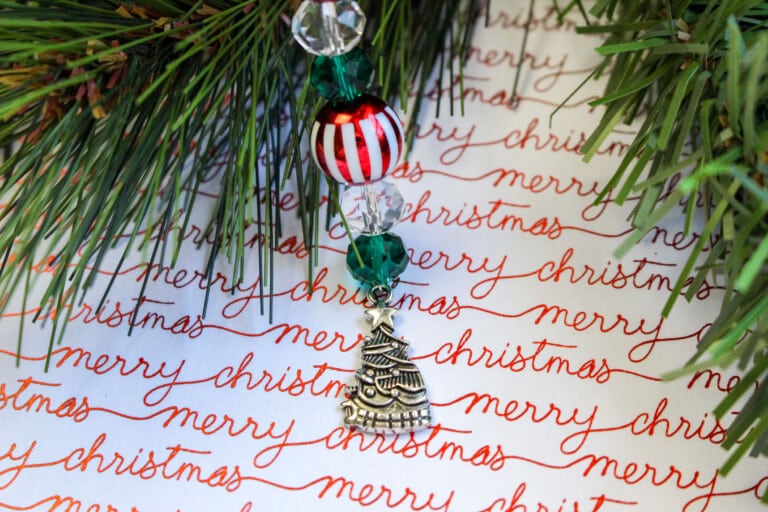 A christmas ornament hangs from a christmas tree.