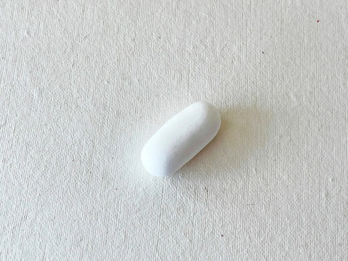 A white bean on a white surface.