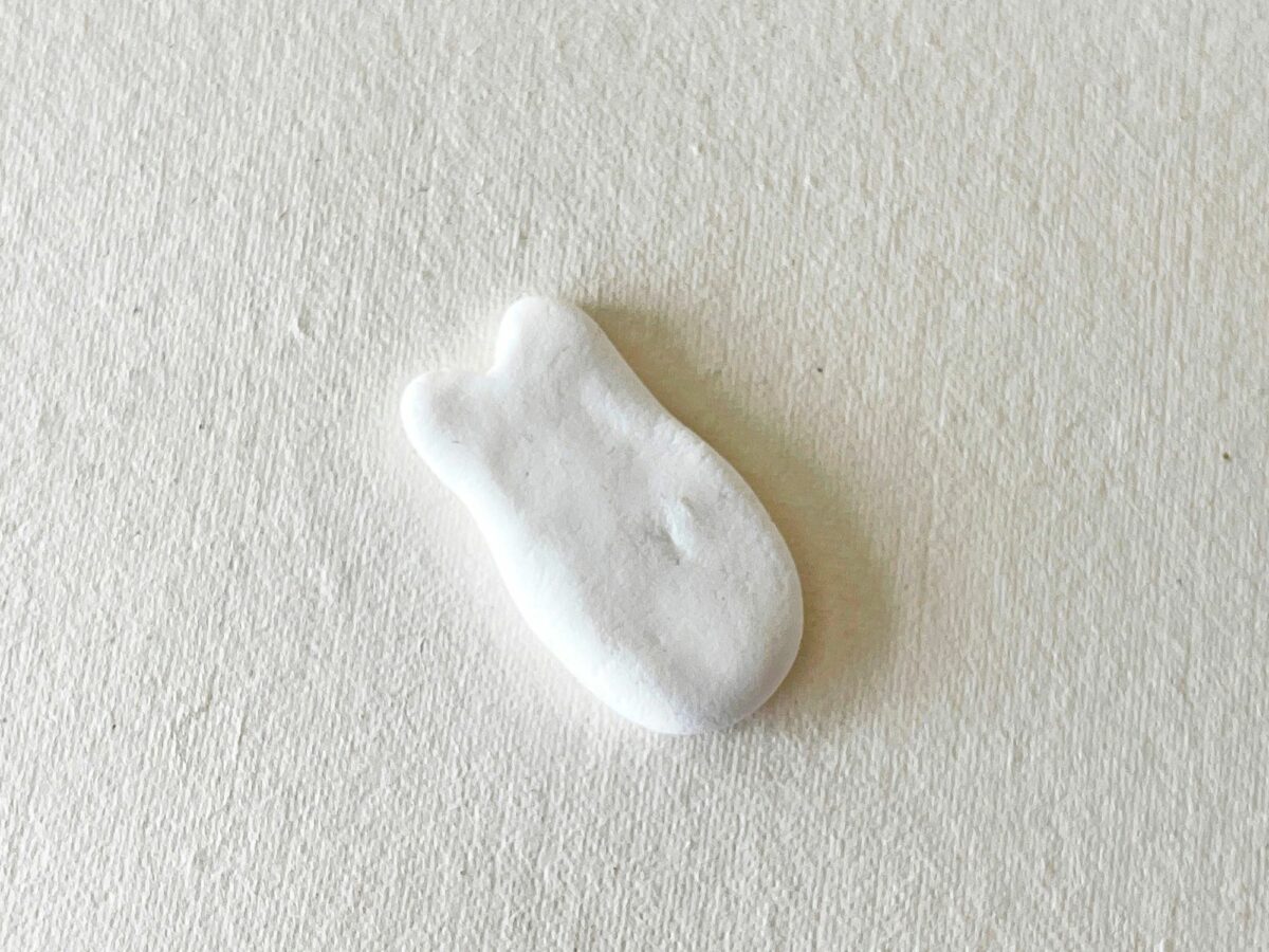 A small white object sitting on a white surface.