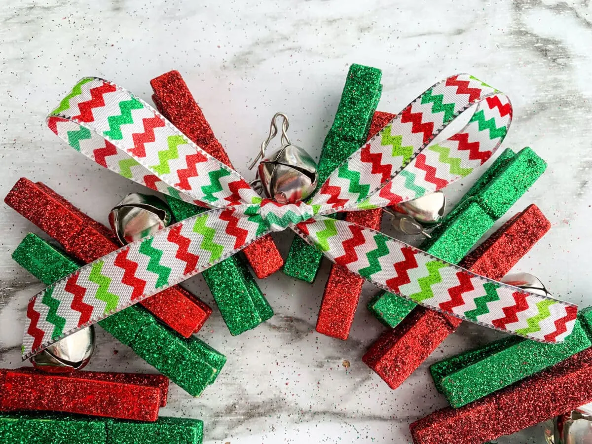 An advent wreath made from clothes pegs and ribbon.