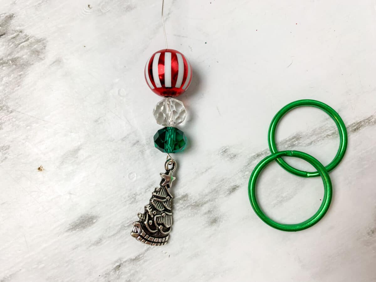 A christmas ornament with red and green beads.