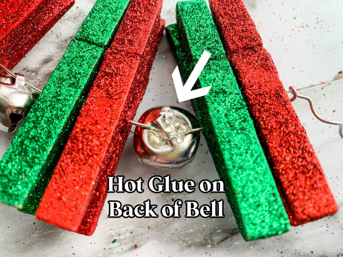Hot glue on back of advent wreath bell.