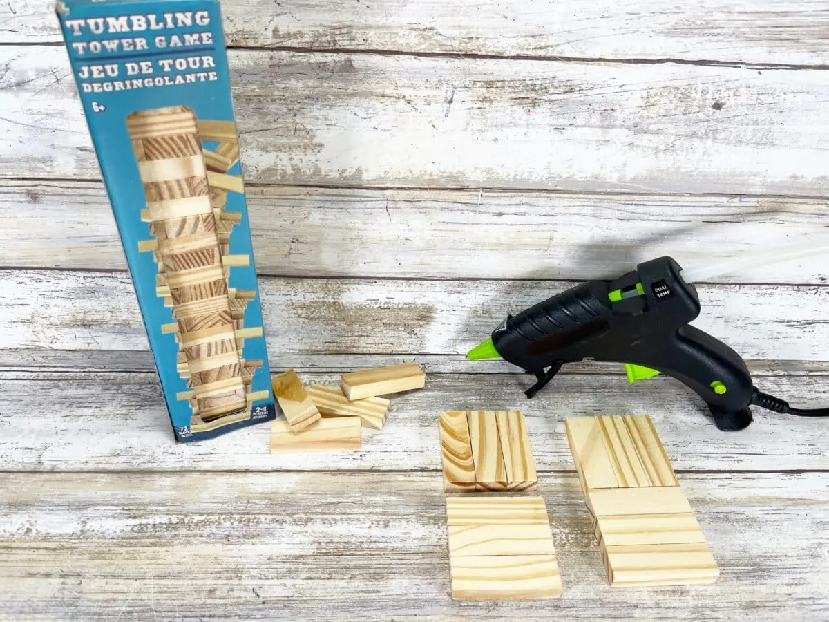 A stack of wooden blocks next to a glue gun.