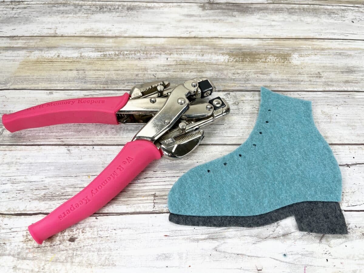 A pair of pliers next to a pair of felt shoes.