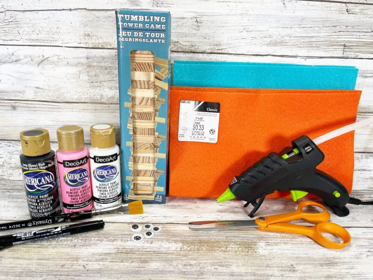 A craft kit with paint, glue, scissors and a bag.