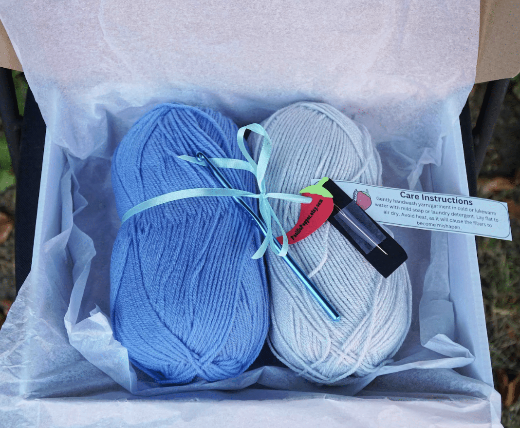 A beginner crochet kit consisting of two balls of yarn in a box.