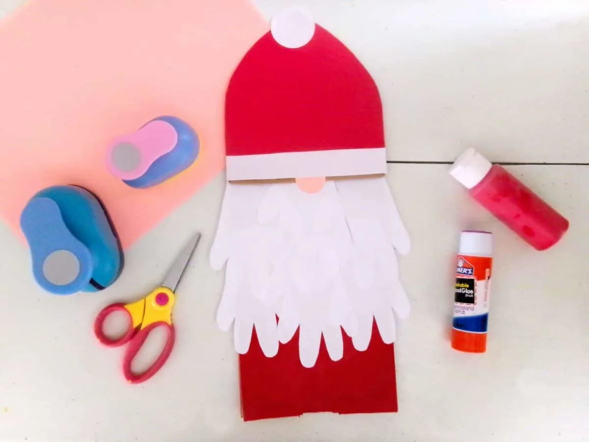 Create a festive Santa Claus paper craft with scissors and glue.