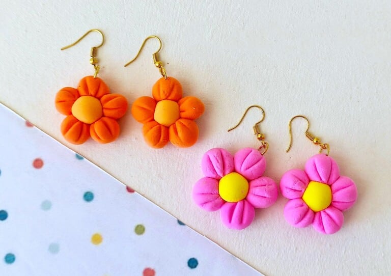 Clay Flower Earrings on a white background with colored polkadots