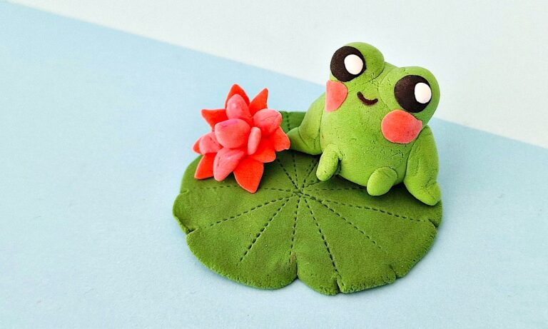 Clay Frog sitting on a blue table top