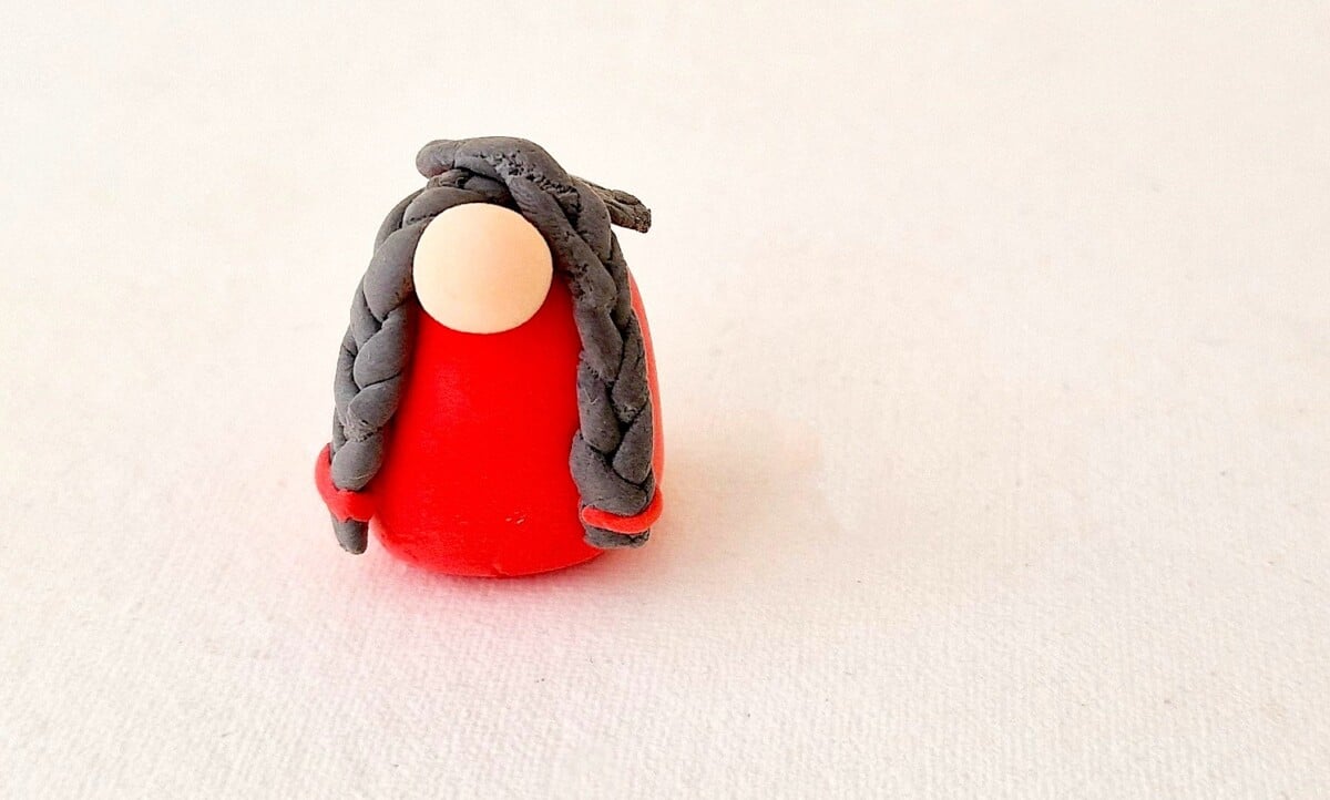 Clay Gnome Step 10 A red and grey plasticine figure.