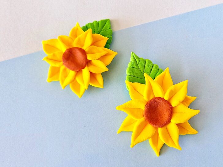 Clay Sunflower with green leaf on blue background