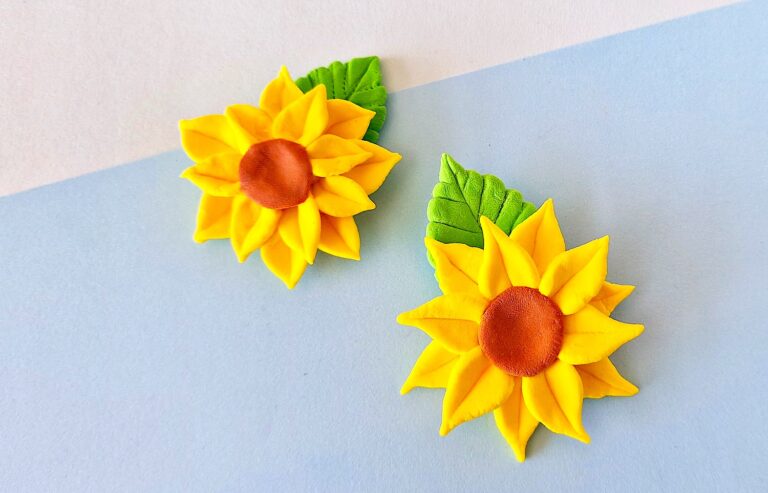Clay Sunflower with green leaf on blue background