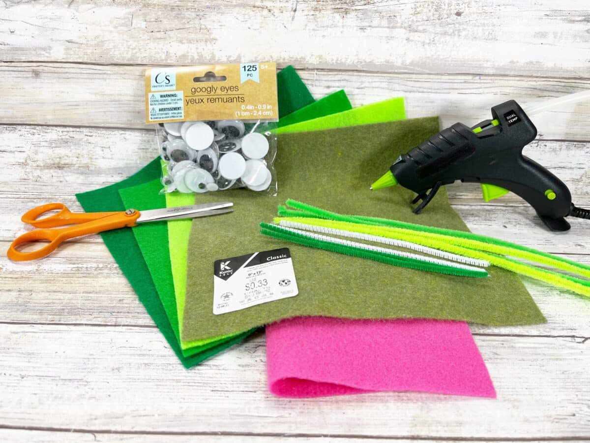 A green felt craft kit with scissors and glue.