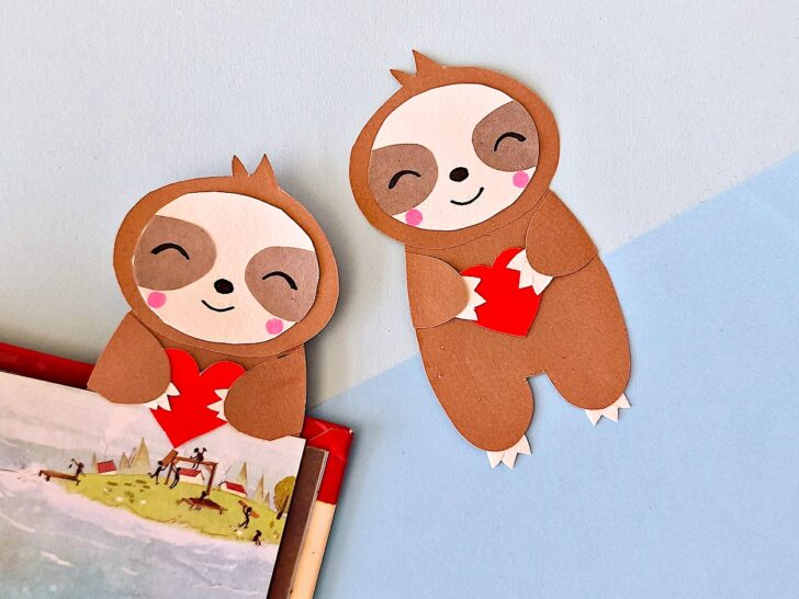 Sloth Bookmark against blue background laying flat