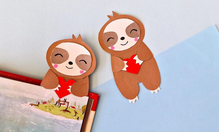 Sloth Bookmark against blue background laying flat